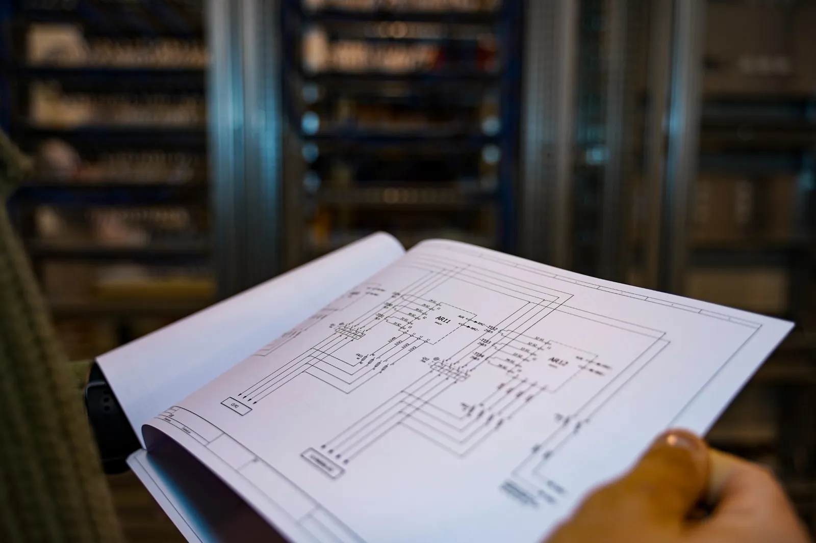 Electrical engineering plans reviewed in an equipment room